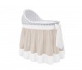 Mobile wicker bed with an ecru flounce and a beige bow