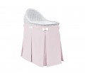 Mobile wicker bed with velvet pink skirt