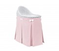 Mobile wicker bed with pink skirt