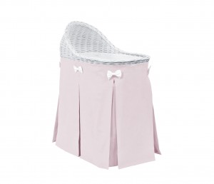 Mobile wicker bed with velvet pink skirt